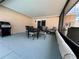 Screened patio with table, chairs, and grill at 829 Pineland Ave, Venice, FL 34285