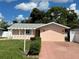 Front view of a charming ranch home with a spacious yard at 829 Pineland Ave, Venice, FL 34285