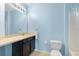 Clean bathroom with dark brown vanity, tan countertop, and bathtub at 8734 Moonlit Meadows Loop, Riverview, FL 33578