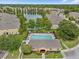 Community pool with lounge chairs and adjacent clubhouse at 8734 Moonlit Meadows Loop, Riverview, FL 33578