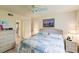 King-size bedroom with ceiling fan, dresser, and ensuite bathroom access at 1515 Forrest Nelson Blvd # H108, Port Charlotte, FL 33952