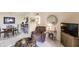 Bright living room features a comfy recliner and dining area at 1515 Forrest Nelson Blvd # H108, Port Charlotte, FL 33952