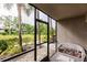 Relaxing screened patio with wicker furniture, overlooking a lush green landscape at 1515 Forrest Nelson Blvd # H108, Port Charlotte, FL 33952