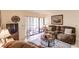 Living room with sliding doors to patio and comfy seating at 1515 Forrest Nelson Blvd # H108, Port Charlotte, FL 33952