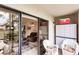 Private screened lanai with white wicker furniture, overlooking a garden at 1515 Forrest Nelson Blvd # H108, Port Charlotte, FL 33952