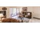 Living area with reclining sofa, view of patio, and tiled floors at 1515 Forrest Nelson Blvd # H108, Port Charlotte, FL 33952