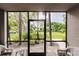 Relaxing screened lanai with view of lush landscaping and trees at 1515 Forrest Nelson Blvd # H108, Port Charlotte, FL 33952