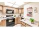 Full kitchen with wood cabinets and granite countertops at 1515 Forrest Nelson Blvd # H108, Port Charlotte, FL 33952