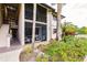 Building exterior showcasing landscaping and screened patio at 1515 Forrest Nelson Blvd # H108, Port Charlotte, FL 33952