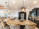 Large kitchen island with seating, granite countertops, and stainless steel appliances at 15378 Taurus Cir, Port Charlotte, FL 33981