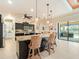 Open kitchen with large island, granite countertops and pool view at 15378 Taurus Cir, Port Charlotte, FL 33981