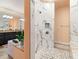 Modern bathroom with a large walk-in shower and marble tile at 15378 Taurus Cir, Port Charlotte, FL 33981