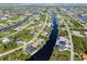 Aerial view showcasing a community with waterfront properties at 15378 Taurus Cir, Port Charlotte, FL 33981
