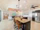 Island kitchen with granite countertops and seating, offering views of the living room at 15378 Taurus Cir, Port Charlotte, FL 33981