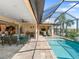 Enclosed pool and patio area with lounge chairs and dining at 15378 Taurus Cir, Port Charlotte, FL 33981