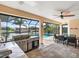Outdoor kitchen with grill, sink and view of the pool at 15378 Taurus Cir, Port Charlotte, FL 33981