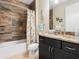 Bathroom with tub, shower, and dark vanity at 15378 Taurus Cir, Port Charlotte, FL 33981