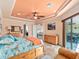 Spacious main bedroom with large bed, water views, and a ceiling fan at 15378 Taurus Cir, Port Charlotte, FL 33981
