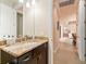 Guest bathroom with granite countertop and dark vanity at 15378 Taurus Cir, Port Charlotte, FL 33981