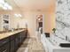 Spa-like bathroom featuring a soaking tub, double vanity, and marble finishes at 15378 Taurus Cir, Port Charlotte, FL 33981