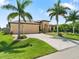 Single-Gathering home with three-car garage, lush landscaping, and palm trees at 15378 Taurus Cir, Port Charlotte, FL 33981