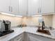 Well-equipped kitchenette with white cabinets, copper sink, and coffee bar at 15378 Taurus Cir, Port Charlotte, FL 33981