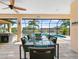 Patio furniture with a view of the pool and canal at 15378 Taurus Cir, Port Charlotte, FL 33981