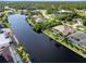 Aerial view of house, pool, and canal at 15378 Taurus Cir, Port Charlotte, FL 33981