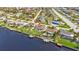 Aerial view showcasing home's location on a canal, near other houses at 806 Ellicott Nw Cir, Port Charlotte, FL 33952