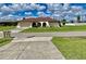 Single story home with red tile roof and attached garage at 181 N Waterway Nw Dr, Port Charlotte, FL 33952