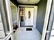 Front entrance with white door and screen enclosure at 181 N Waterway Nw Dr, Port Charlotte, FL 33952