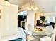 Bright dining area with a glass-top table and chairs adjacent to the kitchen at 181 N Waterway Nw Dr, Port Charlotte, FL 33952