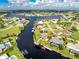 An aerial view showcasing a house with a pool, located on a canal with other homes nearby at 181 N Waterway Nw Dr, Port Charlotte, FL 33952