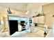 Galley kitchen with black appliances and white cabinets at 181 N Waterway Nw Dr, Port Charlotte, FL 33952