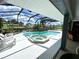 Large pool and spa with a screened enclosure offering privacy and relaxation at 181 N Waterway Nw Dr, Port Charlotte, FL 33952