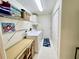 Bright laundry room with washer, dryer, and shelving at 181 N Waterway Nw Dr, Port Charlotte, FL 33952
