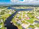 Aerial view of canal front home with lush landscaping and private dock at 181 N Waterway Nw Dr, Port Charlotte, FL 33952