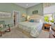 Guest bedroom with king bed and view into bathroom at 3589 Pennyroyal Rd, Port Charlotte, FL 33953