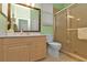 Clean bathroom with light wood cabinets, a shower, and a toilet at 3589 Pennyroyal Rd, Port Charlotte, FL 33953