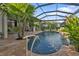 Resort style pool with a covered patio and lush landscaping at 3589 Pennyroyal Rd, Port Charlotte, FL 33953