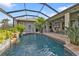 Inviting pool area with a covered patio and lush landscaping at 3589 Pennyroyal Rd, Port Charlotte, FL 33953