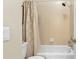 Clean bathroom with a tub, shower, and beige tile at 3589 Pennyroyal Rd, Port Charlotte, FL 33953