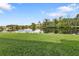 Backyard oasis with pond view and lush landscaping at 3589 Pennyroyal Rd, Port Charlotte, FL 33953