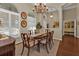 Bright dining room with hardwood floors and a charming table setting at 3589 Pennyroyal Rd, Port Charlotte, FL 33953