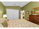 Serene bedroom with a double bed, dresser, and an ensuite bathroom at 3589 Pennyroyal Rd, Port Charlotte, FL 33953