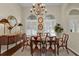 Elegant dining room with hardwood floors, a large table, and a chandelier at 3589 Pennyroyal Rd, Port Charlotte, FL 33953