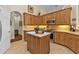 Kitchen with wood cabinets, stainless steel appliances, and an island at 3589 Pennyroyal Rd, Port Charlotte, FL 33953