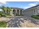 Attractive single-story home with paver driveway and landscaping at 3589 Pennyroyal Rd, Port Charlotte, FL 33953