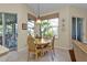 Bright breakfast nook with a round table and chairs, overlooking the backyard at 3589 Pennyroyal Rd, Port Charlotte, FL 33953