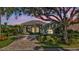 Charming house with a paver driveway at dusk at 3589 Pennyroyal Rd, Port Charlotte, FL 33953